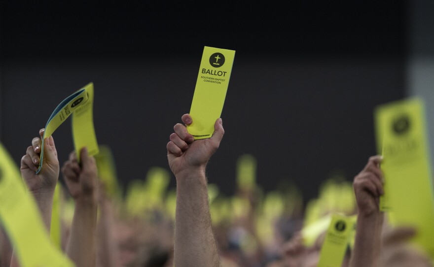 Attendees hold up their ballots during the Southern Baptist Convention's annual meeting in Anaheim, Calif.