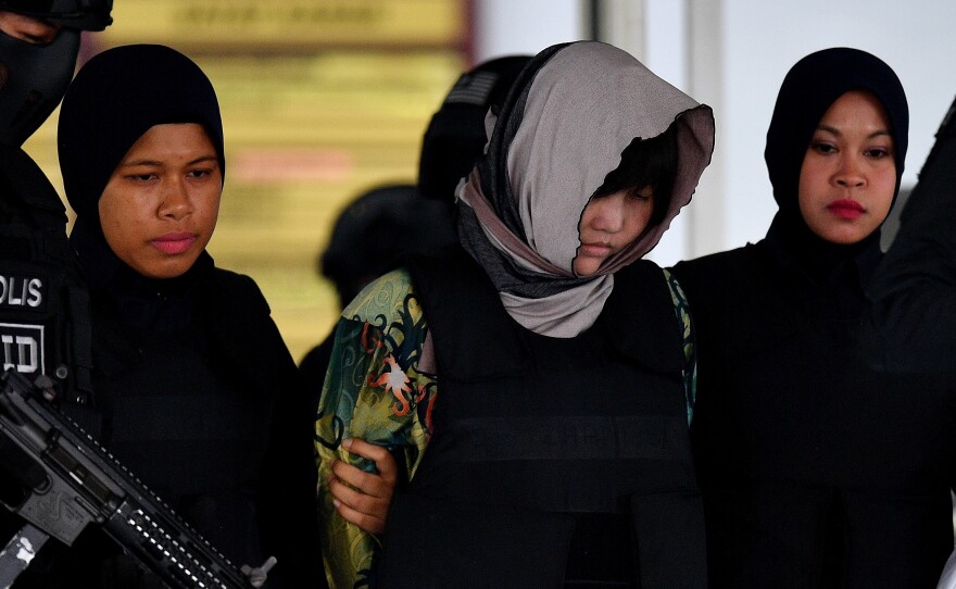 Vietnamese national Doan Thi Huong (center), escorted by armed Malaysian police, leaves after facing trial at the Shah Alam High Court outside Kuala Lumpur on Thursday.