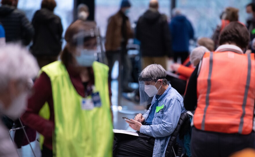 Workers and patients at a pop-up COVID-19 vaccination site near downtown Seattle in January. "The vast majority who are coming in do appear to be meeting the eligibility criteria," says Dr. Jeff Duchin, King County's public health officer.