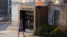 A person walks by the Ithaca Police Department headquarters on March 22, 2021, in Ithaca, N.Y.