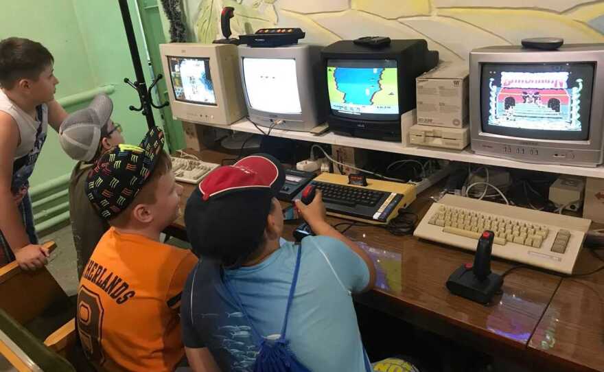Kids play on retro computers in the IT 8-bit museum in Mariupol, Ukraine before it was attacked.