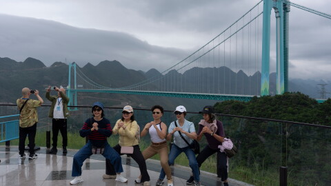 Tourists pose for photos near the Huajiang Grand Canyon Bridge, considered to be the world's highest bridge, in Anshun in southwestern China's Guizhou province on Friday, May 29, 2026.