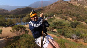 Host Jorge Meraz flies high across zip-lines on the canopy tour at the Las Cañadas Campground.