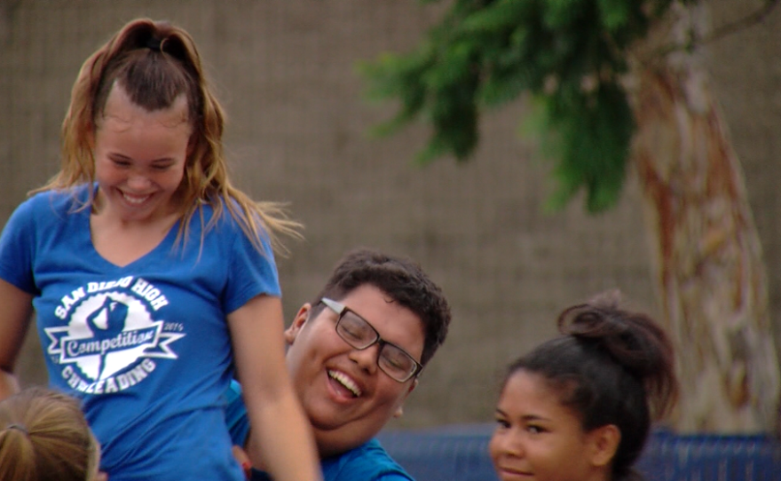 San Diego High School student Marco Manzo catches Emily Uribe, his cheer team's flyer, while practicing a new stunt, July 25, 2016.