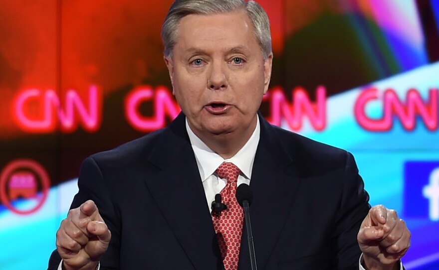 Republican Presidential candidate Lindsey Graham gestures as he thanks American Muslims for their military service during Tuesday's debate.