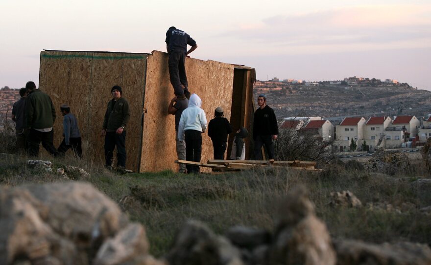 Jewish settlers from Kiryat Arba and Kharsina in the West Bank start to re-build houses at a nearby unauthorized outpost, on Feb. 21. The Israeli government considers the outposts illegal and occasionally tears them down.