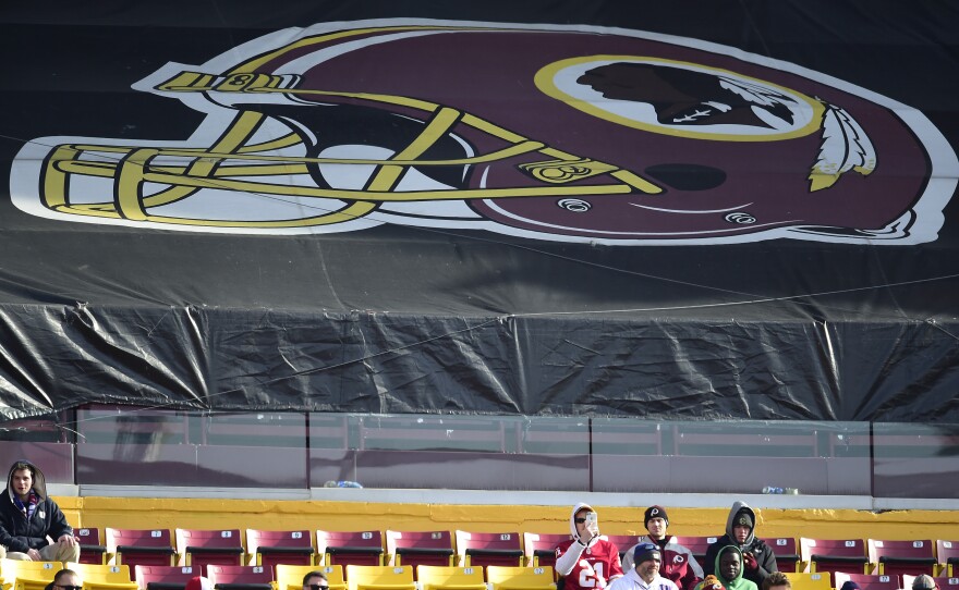Fans sit in the stands before the start of a game between the New York Giants and Washington Redskins at FedEx Field in 2019 in Landover, Md. The Redskins, and other teams, are reviewing their names.
