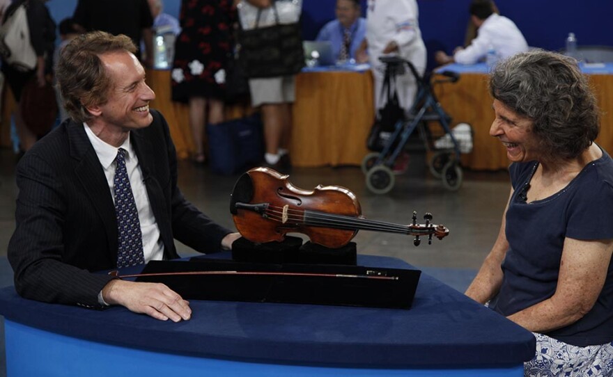 David Bonsey (left) appraises a Gagliano Family violin & Francois Nicolas voirin bow, in Phoenix, Ariz.