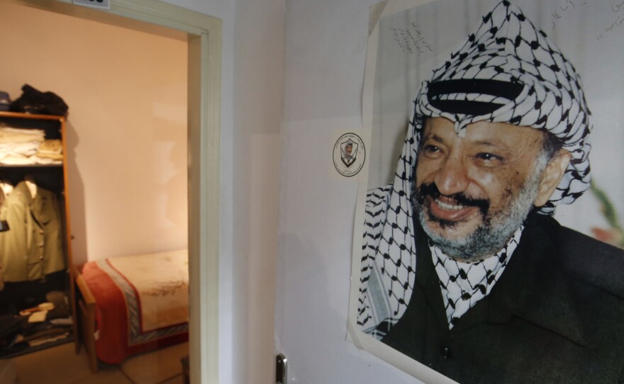 A photograph of the late Palestinian leader Yasser Arafat hangs outside a door leading to the small bedroom where he spent his final years, a display at the new Arafat Museum in the West Bank city of Ramallah.