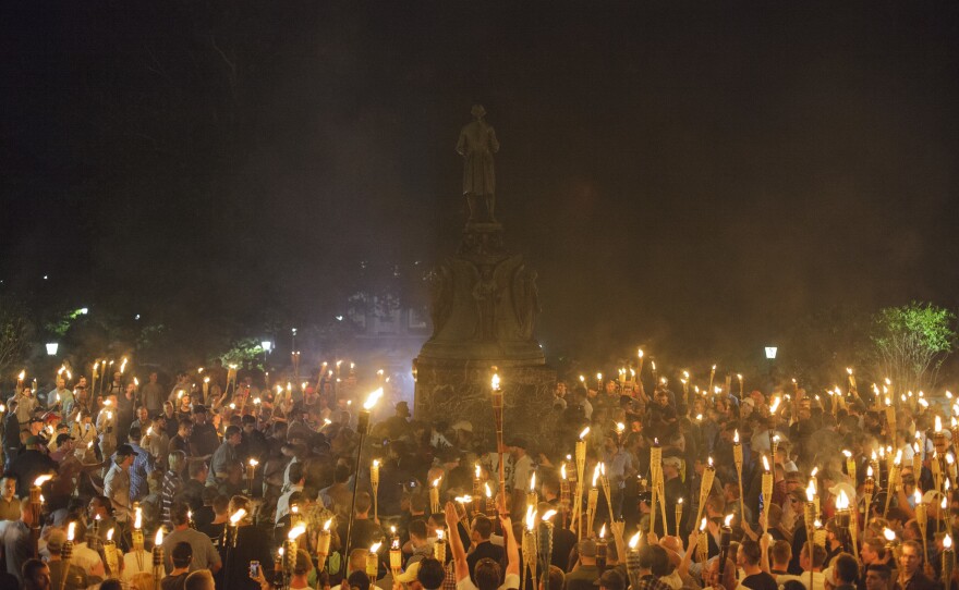 Neo-Nazis, alt-right supporters and white supremacists encircle counter-protestors at the base of a statue of Thomas Jefferson after marching through the University of Virginia campus with torches in Charlottesville, Va., on Aug. 11, 2017.