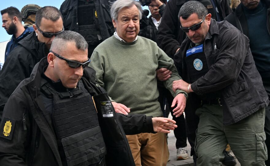 U.N. Secretary-General Antonio Guterres walks with security personnel as his visits Borodyanka, a town outside Kyiv that was devastated by a Russian attack and occupation, on Thursday. Russia sent a deadly attack into the capital as Guterres visited.