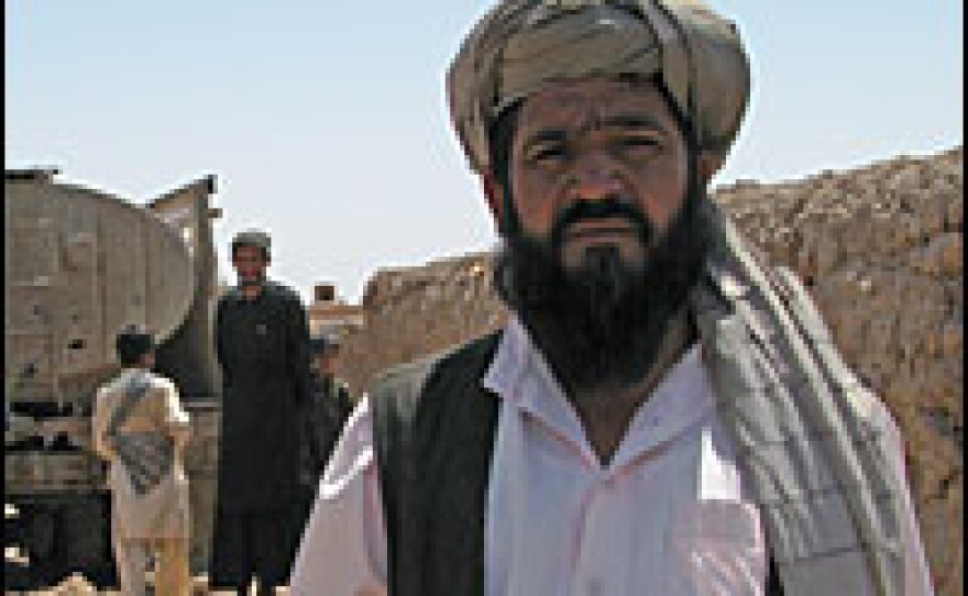 Abdul Abdul Rashid stands in front of a tanker bringing badly needed water to his drought-ridden village. The tanker was destroyed in the U.S.-Afghan operation.