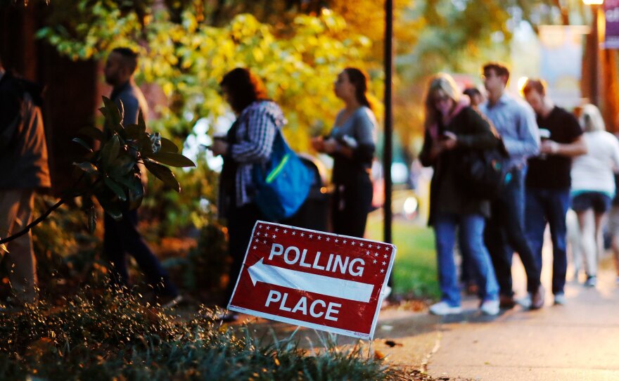 A line forms outside a polling site on election day in Atlanta on Tuesday. More than 47 percent of the voting-eligible population cast a ballot in the midterm elections on Tuesday according to early estimates from the United States Election Project.