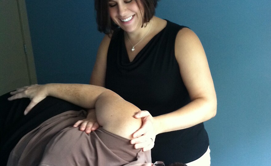 Physical therapist Jennifer Goyette provides manual lymphatic drainage therapy to cancer survivor Deborah Leonard.