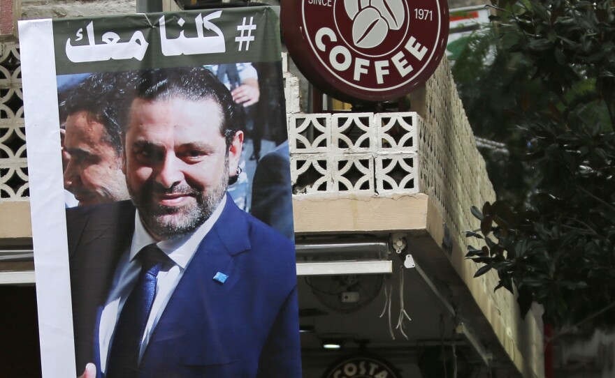 A poster of resigned Lebanese Prime Minister Saad Hariri with Arabic that read, "We are all with you," hangs on a street in Beirut, Lebanon, on Monday.