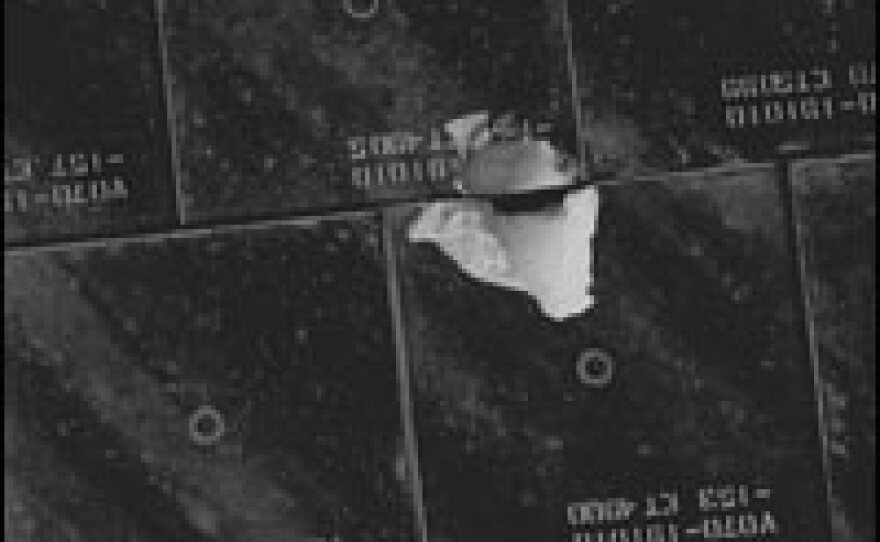 A close-up view of damaged tile on the underside of the Space Shuttle Endeavour.