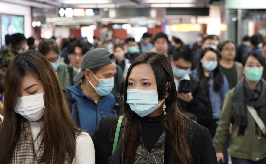 Passengers in a subway station in Hong Kong on Wednesday wear masks amid the coronavirus outbreak.