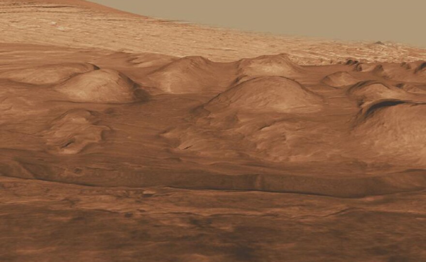 This oblique view of the lower mound in Gale crater shows layers of rock that preserve a record of environments on Mars. Here, orbiting instruments have detected signatures of both clay minerals and sulfate salts, with more clay minerals apparent in the foreground of this image and fewer in higher layers. This change in mineralogy may reflect a change in the ancient environment in Gale Crater.
