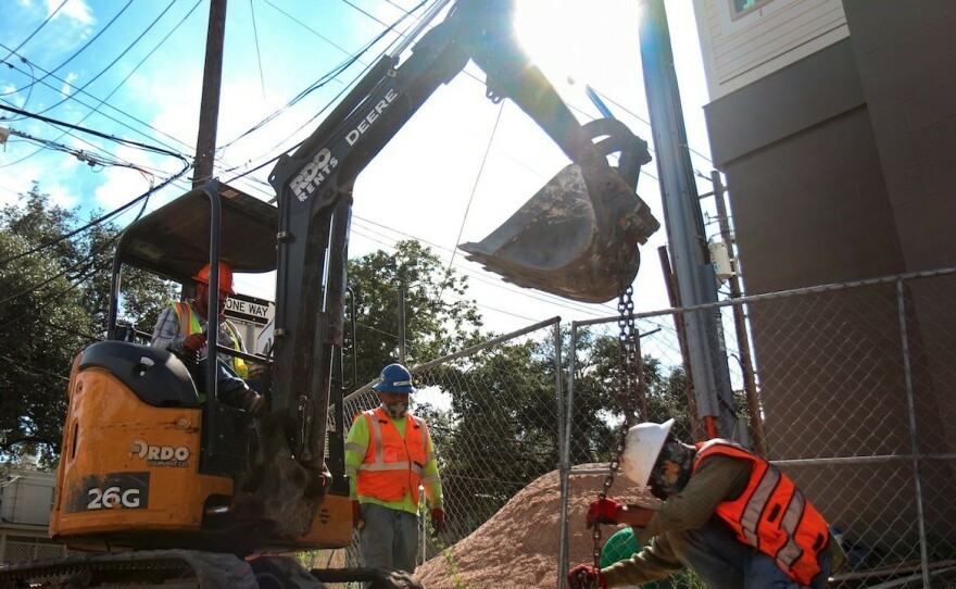 Austin, Texas, construction workers dig on a hot day in August 2021. Last month, Gov. Greg Abbott signed a bill that overturns local ordinances in some Texas cities that mandate regular rest breaks for such workers.