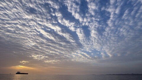 The sun rises behind a tanker anchored in the Strait of Hormuz off the coast of Qeshm Island, Iran, Saturday, April 18, 2026.