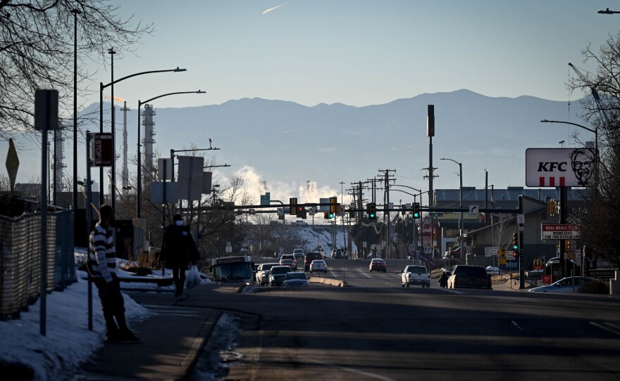 The hustle and bustle of Commerce City, Colo., unfolds in the foreground as Colorado's Rocky Mountains stand tall in the distance.