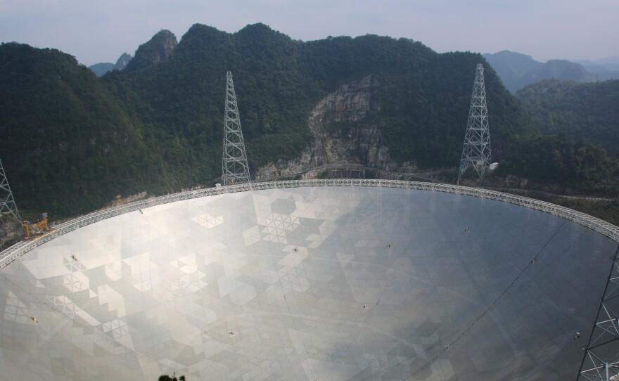 The world's largest radio telescope is nestled among the jagged, green mountains of southwest China's Guizhou Province.