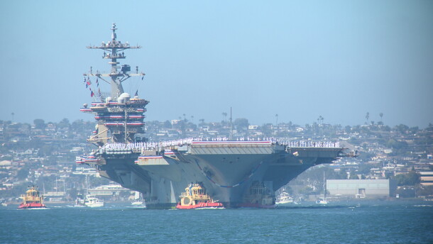 Tug boats maneuver the USS Abraham Lincoln into its dock on Naval Air Station North Island on Oct. 8, 2026. The Lincoln returned from a 10-month extended deployment to the Middle East.