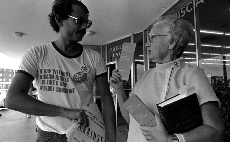 Doris Dennis, a volunteer handing out literature for the Save Our Children group headed by Anita Bryant, gets into a debate with Alan Rockway, a volunteer handing out literature for a gay rights group, at a shopping center in Miami in 1977.