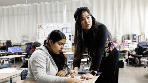 Mary Acebu, a special education teacher at Riverview Middle School in Bay Point, Calif., works with a student during a math lesson. She says using AI to help with the paperwork part of her job allows her to spend more time interacting with her students in a meaningful way.