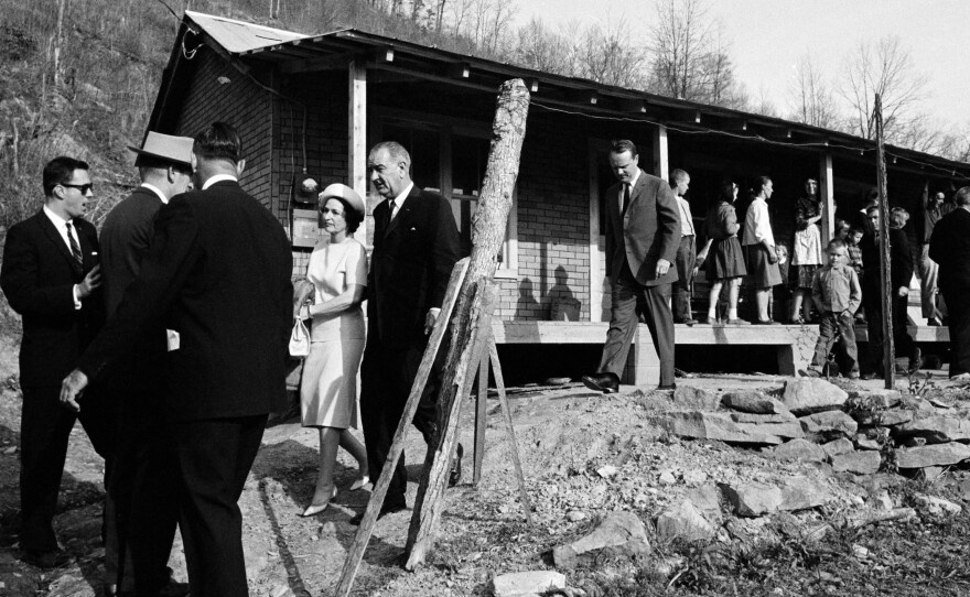 President Lyndon Johnson and his wife, Lady Bird, leave a home in Inez, Ky., during a 1964 visit to Martin County.