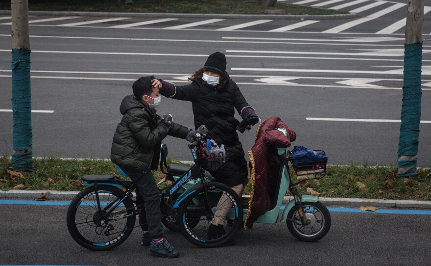 A mother and son go for a bike ride.