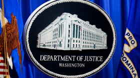 The U.S. Department of Justice logo is before a news conference, Monday, May 4, 2026, in Washington.
