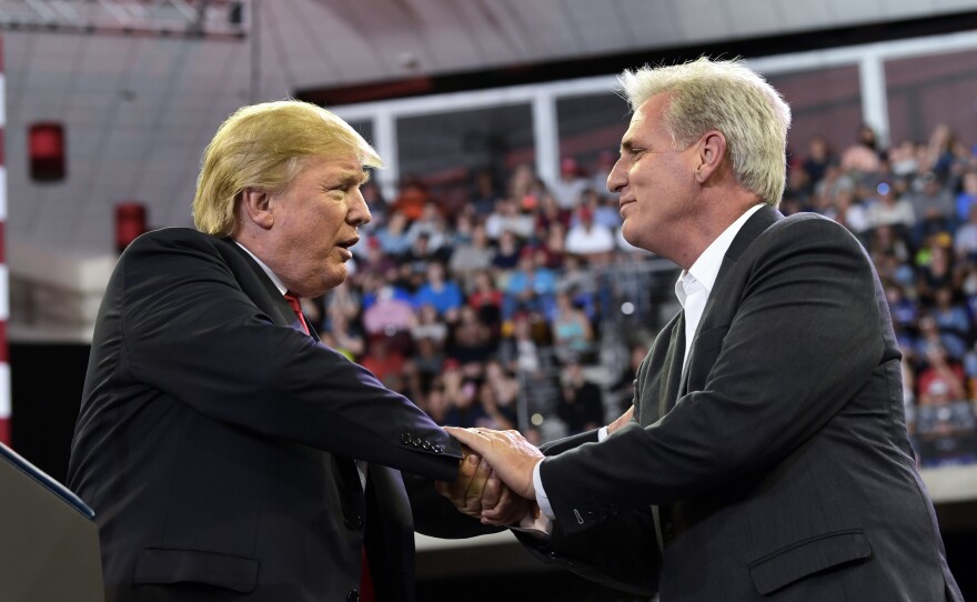 President Trump shakes hands with House Majority Leader Kevin McCarthy during a rally this summer. If Republicans keep their majority, McCarthy could be the next speaker of the House.