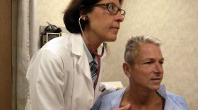 Internist Nesli Basgoz examines patient Barry Arcangeli who has a leaky heart valve. Basgoz discovered Arcangeli's heart condition during a routine physical examination.