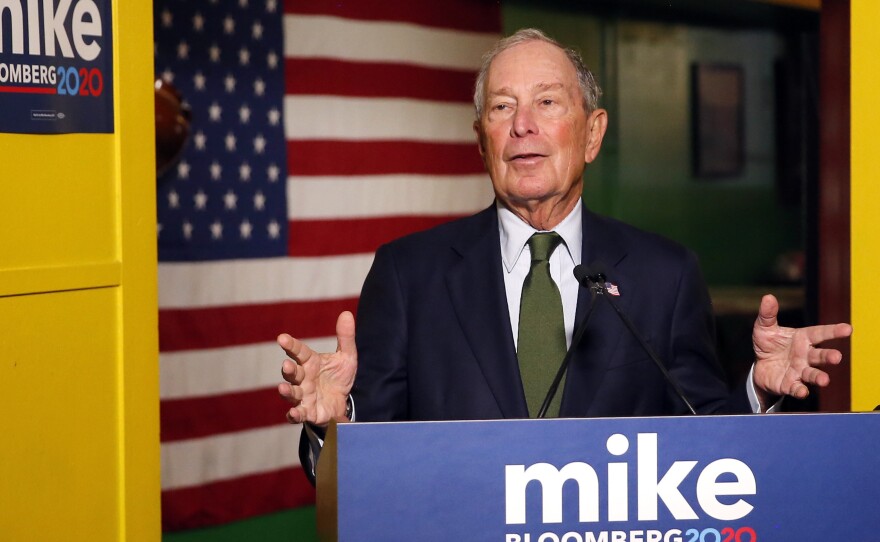 Former New York Mayor Mike Bloomberg speaks to the media in Phoenix. Bloomberg, who's running for president, is spending millions on TV ads but not competing in Iowa or New Hampshire.