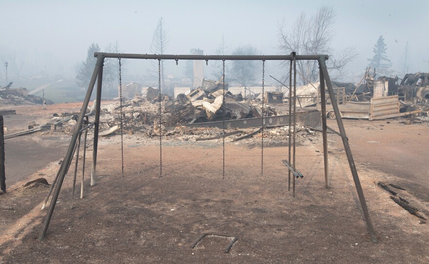 Swings were burned away in a residential neighborhood destroyed by a wildfire in Fort McMurray, Alberta, Canada on Friday.