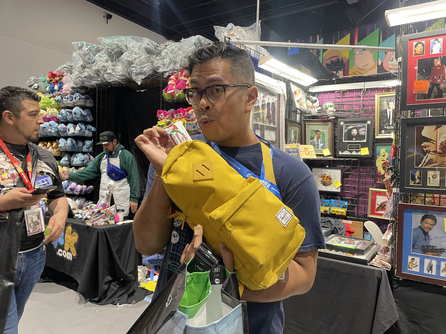 Patrick Mayuyu pulls a Trader Joe’s snack bar from his backpack at San Diego Comic-Con on Saturday, July 25, 2025.