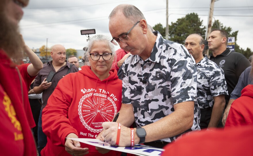 UAW President Shawn Fain greets union members as they strike the General Motors Lansing Delta Assembly Plant in Lansing, Mich., on Sept. 29, 2023. So far, the UAW has not yet targeted the most profitable parts of the Big Three automakers' production.