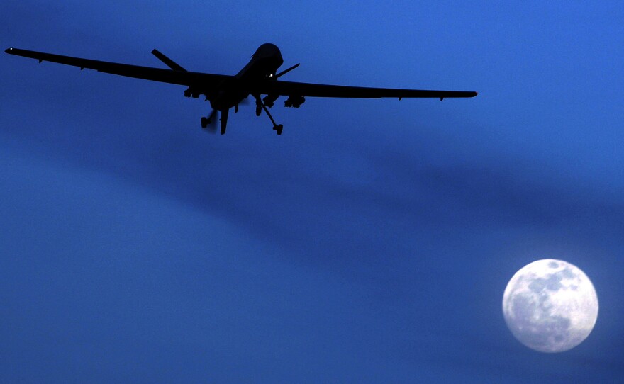 A U.S. Predator drone flies over Kandahar Air Field, southern Afghanistan, on a moonlit night in 2010. The U.S. military has increasingly turned to drones in Syria, Iraq and Afghanistan, where the military carries out airstrikes daily.