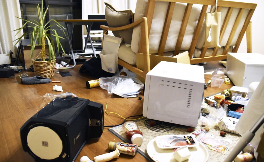 Furniture and electrical appliance are scattered at an apartment in Fukushima, northern Japan, on Wednesday.