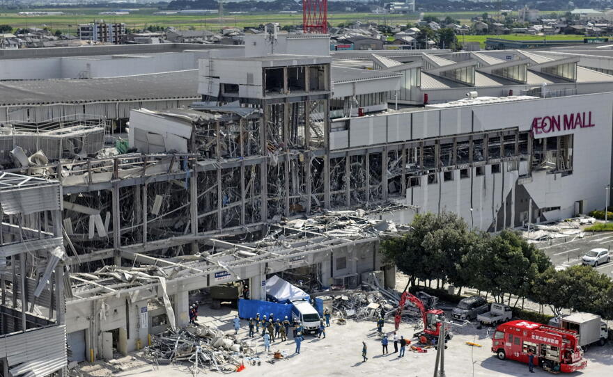 In this aerial image taken with a drone, responders work outside AEON Mall Kumamoto after an explosion occurred following an earthquake, in Kashima, Kumamoto Prefecture, southern Japan, Thursday, July 30, 2026.