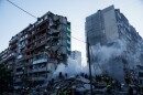 Rescue workers clear the rubble of a house heavily damaged after a Russian strike on a residential neighborhood in Kyiv, Ukraine, on Thursday, May 14, 2026.