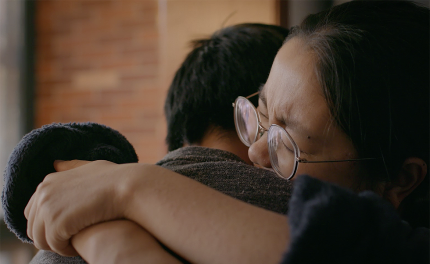 Driver and wife hug.