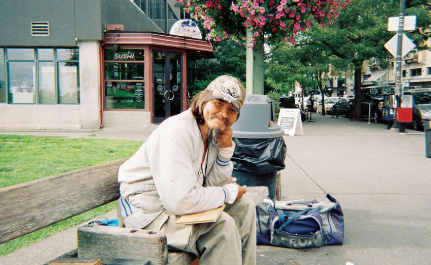 In a photo taken just hours before his death, John T. Williams sits at Victor Steinbrueck Park in Seattle. Williams would carve here regularly.