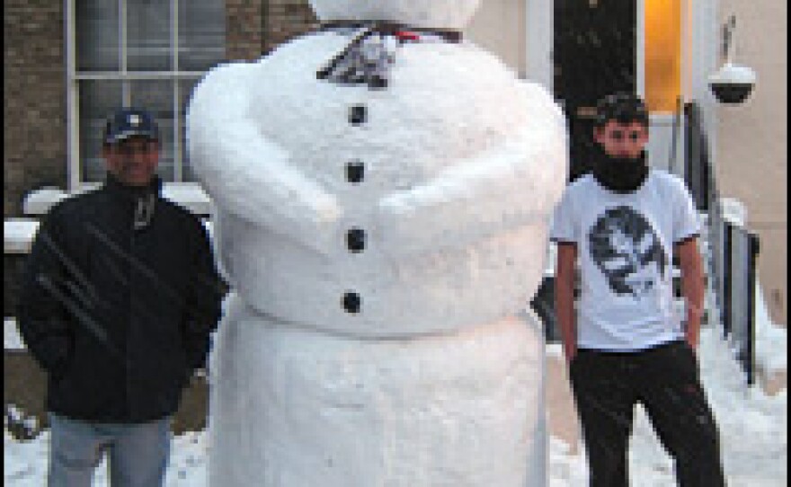 Hussein Nawal and his son, Dean, stand beside the snowman they built in Crystal Palace, South London, on Feb. 2.
