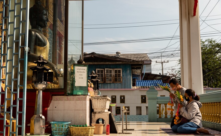 Passersby pray at the Thamniyom temple in Ayutthaya, a city an hour north of Bangkok.