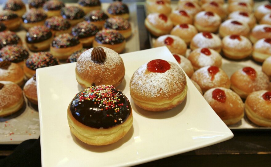 Jews commemorate Hanukkah by eating fried foods. For most American Jews, that means latkes — potato pancakes fried in oil. But other cultures toss different foods into pots of boiling oil. Take, for example, these fried and jam-filled doughnuts, called sufganiyot in Hebrew, on display at a bakery in Kadima in central Israel.