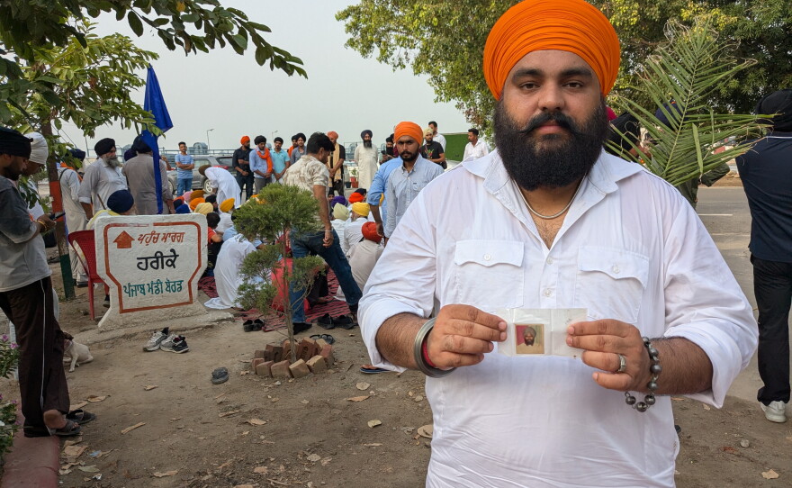 Ranjit Singh Babbar shows a photograph of his father Atma Singh who he says was abducted and killed by the Punjab police during in 1990.