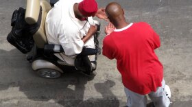 Looking down from his rooftop lookout post to a homeless shelter on Skid Row in Los Angeles, LAPD senior lead officer Deon Joseph says: "See that guy in the wheelchair right  there? Looks like he may be trying to stuff a crack pipe ... Yup, he just made a drug deal."