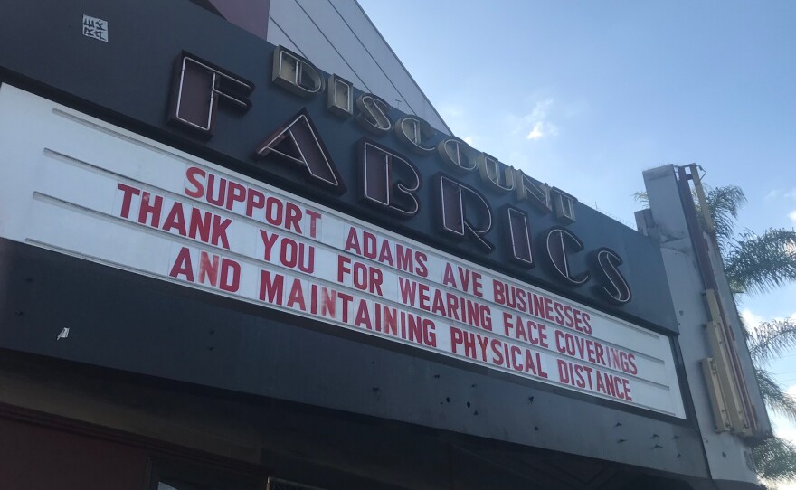A sign thanks patrons of Adams Avenue businesses for following COVID-19 precautions on the marquee of the shuttered Discount Fabrics in Normal Heights. Dec. 10, 2020.